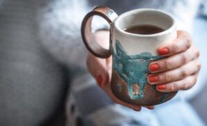 girl holding a cup of tea in hands
