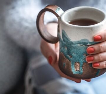 girl holding a cup of tea in hands
